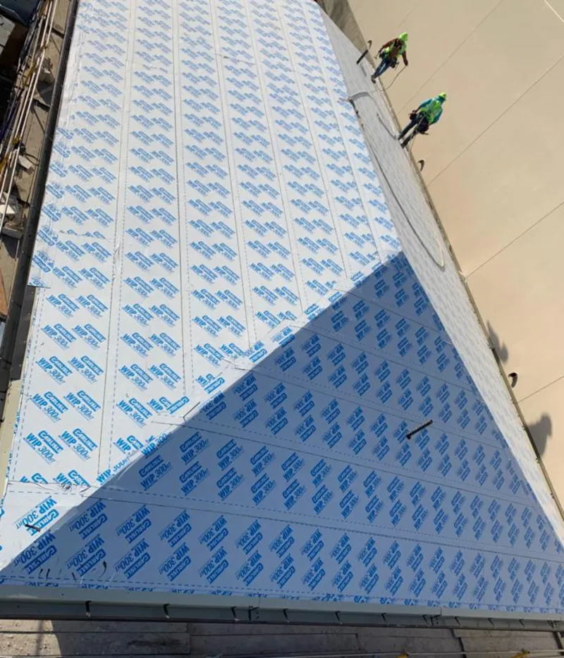 Professional roofers installing underlayment on a metal roof in Scenic Oaks